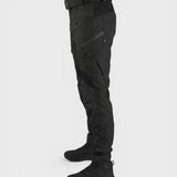 Alexandra Oradea Albert black tactical utility pants with multiple zippered pockets and adjustable ankle straps.